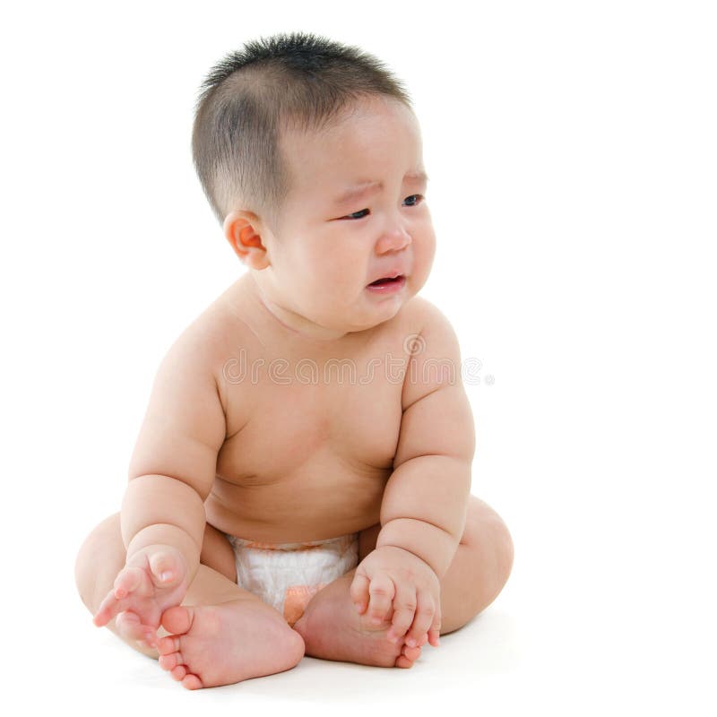 Full body sad Asian baby boy crying, sitting isolated on white background. Full body sad Asian baby boy crying, sitting isolated on white background