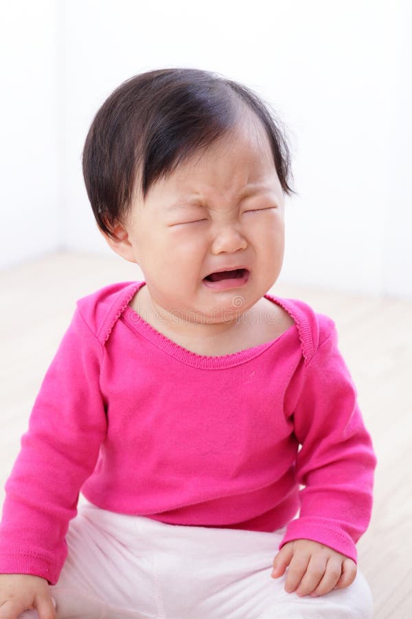 Portrait of crying baby girl on living room at home, asian child. Portrait of crying baby girl on living room at home, asian child