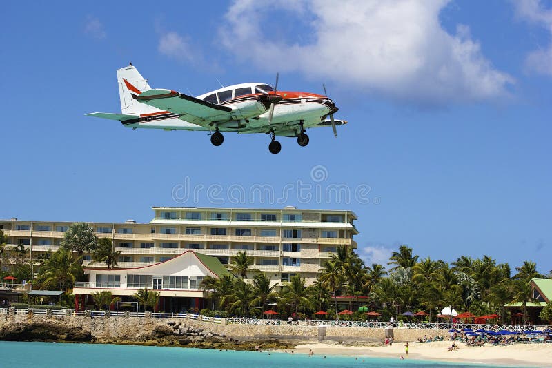 Small private Plane landing in Maho bay in St Maarten, Caribbean. Small private Plane landing in Maho bay in St Maarten, Caribbean