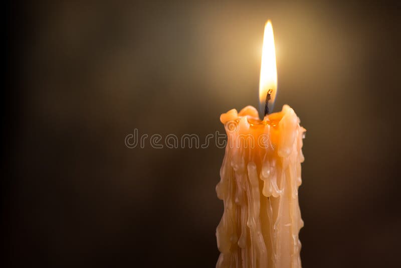 Candle flame close up on a dark background. Melted Wax Candle light border design. Burning at Night, Darkness. Candlelight. Candle flame close up on a dark background. Melted Wax Candle light border design. Burning at Night, Darkness. Candlelight.