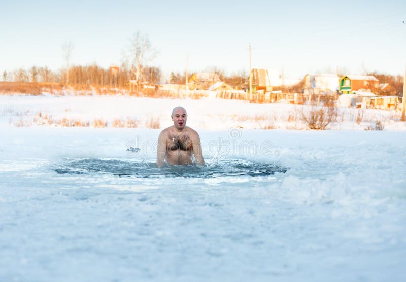 Winter-swimmer in ice-hole at lake a frosty morning. Winter-swimmer in ice-hole at lake a frosty morning