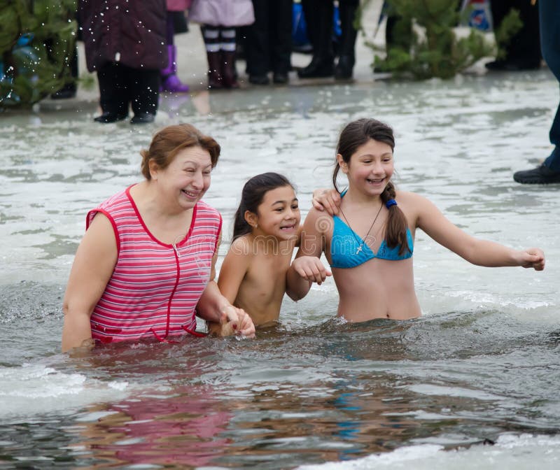 The religious feast of the Epiphany. People bathe in the winter in the ice in the river. The religious feast of the Epiphany. People bathe in the winter in the ice in the river.