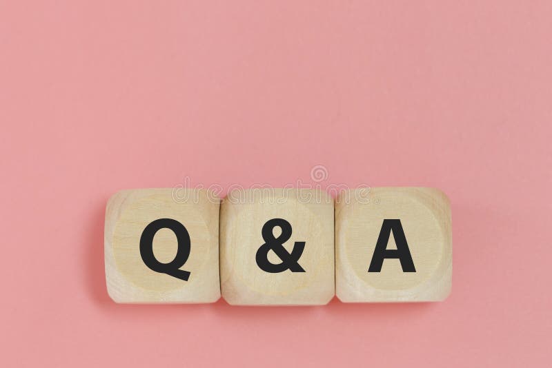 q-and-a-text-on-wooden-cube-block-pink-background-word-question-answer