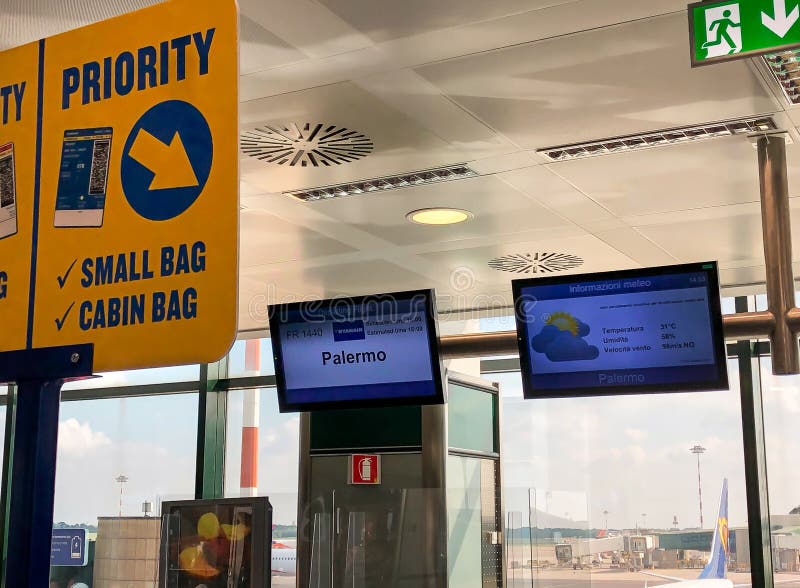 Ferno, Milan-Malpensa, Italy - September 23, 2020: Scoreboard at low cost airline company Ryanair for Palermo flight inside the Milan-Malpensa airport Terminal 1. Ferno, Milan-Malpensa, Italy - September 23, 2020: Scoreboard at low cost airline company Ryanair for Palermo flight inside the Milan-Malpensa airport Terminal 1
