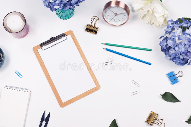 Quadro feminino do espaço de trabalho da mesa com arranjo da beleza de hortênsias do ramalhete, de prancheta, de copo de café, de fotos de stock royalty free Quadro feminino do espaço de trabalho da mesa com arranjo da beleza de hortênsias do ramalhete, de prancheta, de copo de café, de fotos de stock royalty free