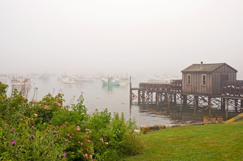 Quaint fishing wharf in fog