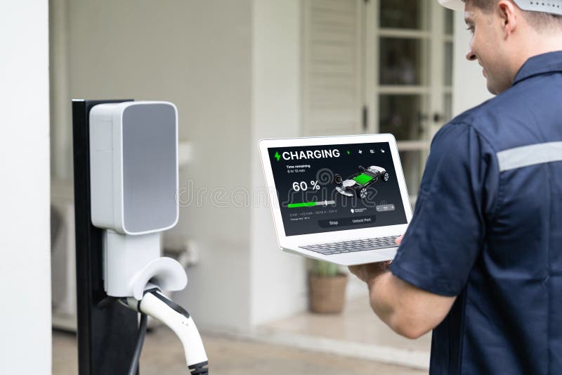 Qualified Technician Working with Laptop for Home EV Station