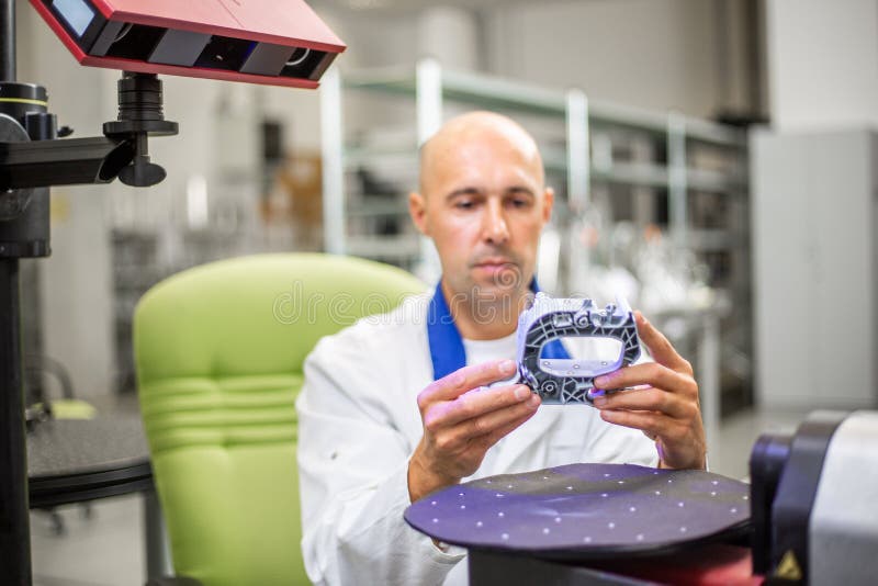 Quality engineer scanning some moldings component by professional optical 3D scanner, automotive concept. Quality engineer scanning some moldings component by stock photo Quality engineer scanning some moldings component by professional optical 3D scanner, automotive concept. Quality engineer scanning some moldings component by stock photo