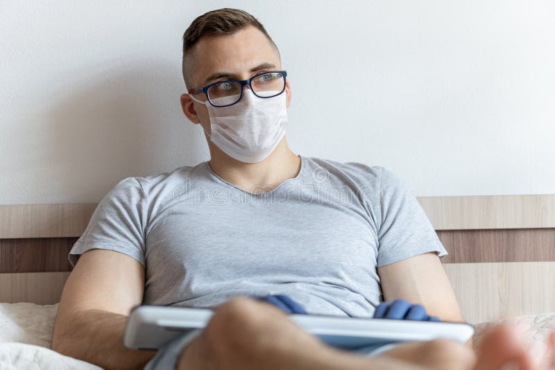 The quarantined guy works remotely from home. Communication, people and freelance work concept stock photo