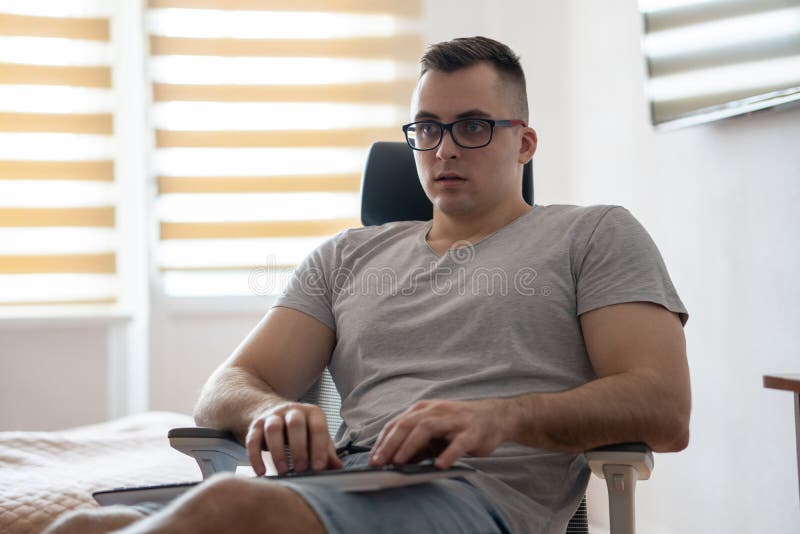The quarantined guy works remotely from home. Communication, people and freelance work concept stock photos
