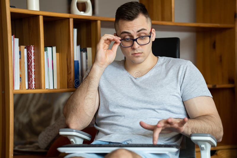 The quarantined guy works remotely from home. Communication, people and freelance work concept stock image