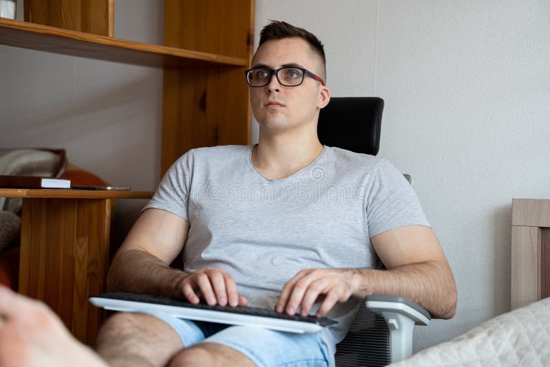 The quarantined guy works remotely from home. Communication, people and freelance work concept stock image