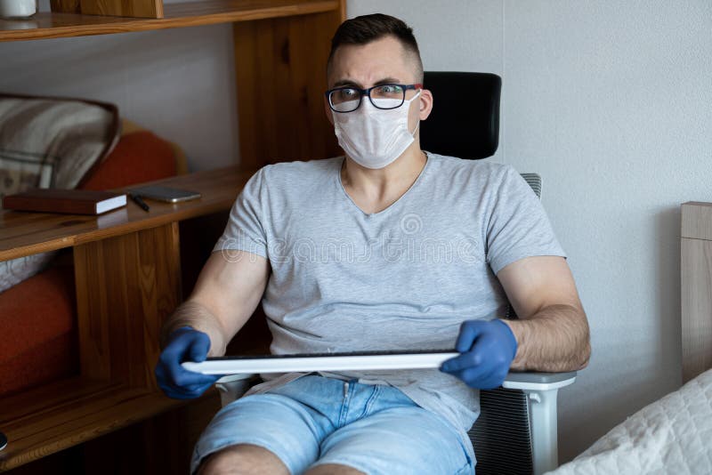 The quarantined guy works remotely from home. Communication, people and freelance work concept royalty free stock photo