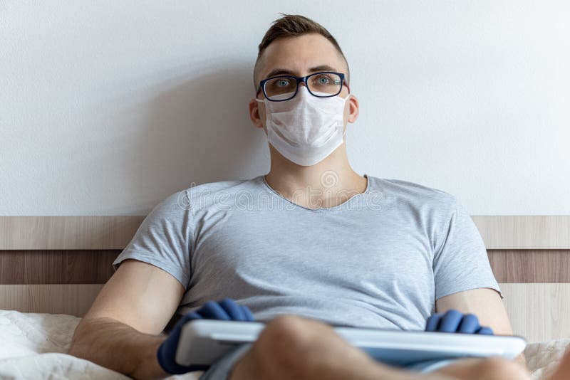 The quarantined guy works remotely from the hospital. Communication, people and freelance work concept royalty free stock images