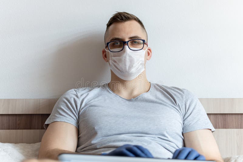 The quarantined guy works remotely from the hospital. Communication, people and freelance work concept stock photos