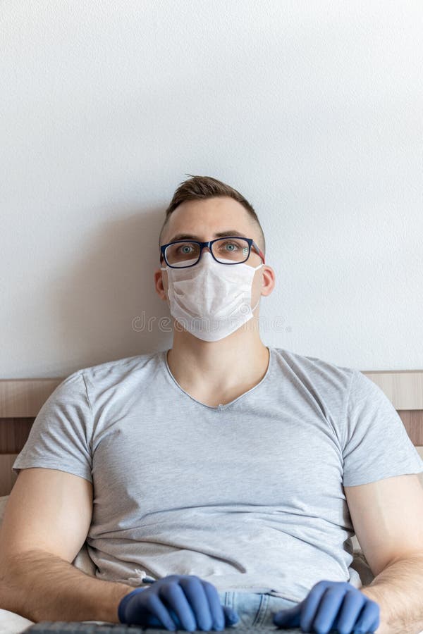 The quarantined guy works remotely from the hospital. Communication, people and freelance work concept royalty free stock image