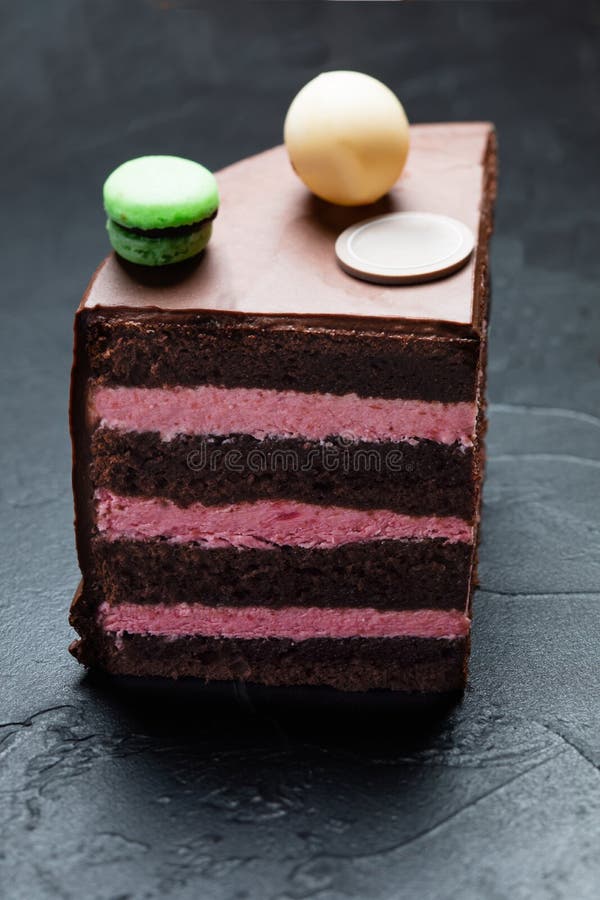 The Quarter of a Chocolate Cake with Macaroons on the Top Stock Image