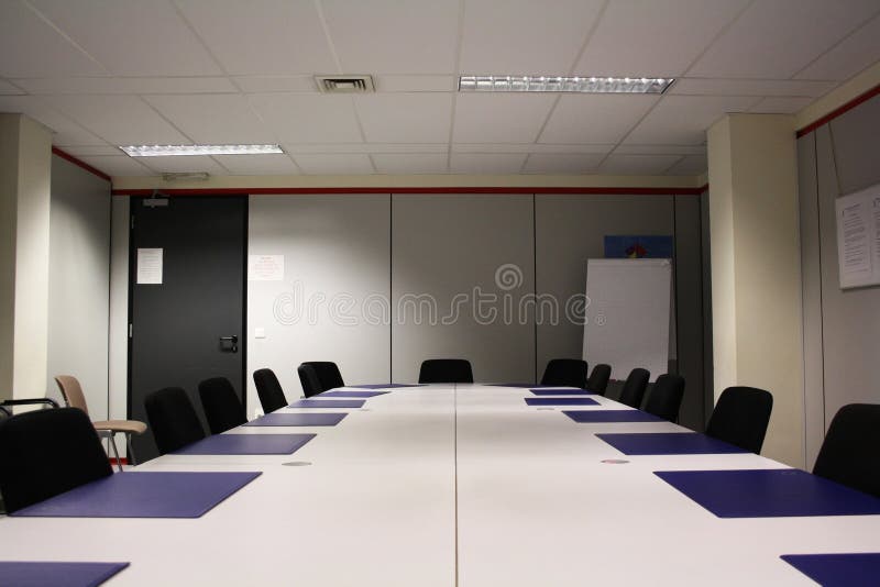 A gray, ordinary, empty meeting room. A gray, ordinary, empty meeting room.
