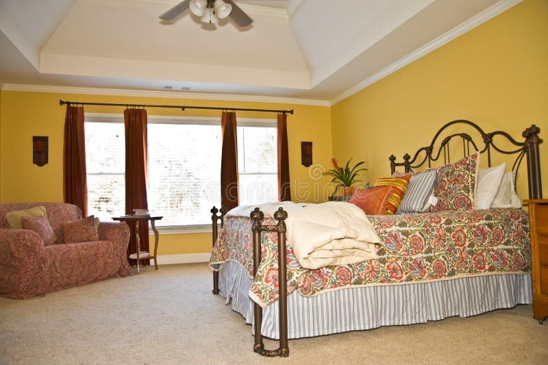 A beautiful, bright, modern bedroom decoratively furnished and showing the tray ceiling. A beautiful, bright, modern bedroom decoratively furnished and showing the tray ceiling.