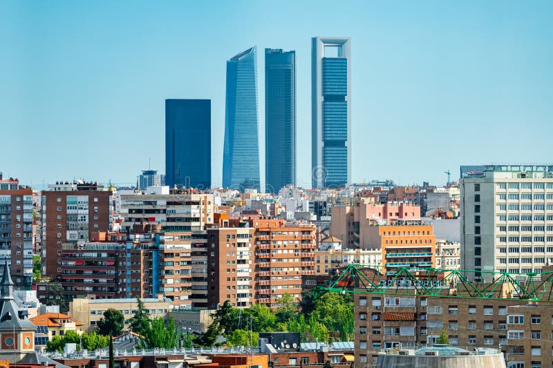 Four skyscraper towers of Madrid emerging among the buildings of the city, Spain. Four skyscraper towers of Madrid emerging among the buildings of the city, Spain