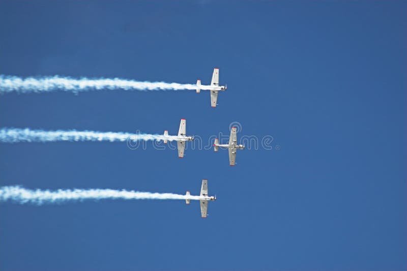 Four planes fly in formation with vapor trails. Four planes fly in formation with vapor trails