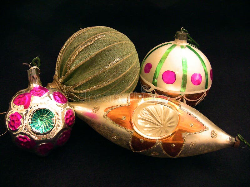 Naples, Italy - December 1, 2016: four Christmas tree balls isolated on a black background,one green and brown,one white with green stripes and magenta circles, one oval with a picture of flower and one of irregular form. Naples, Italy - December 1, 2016: four Christmas tree balls isolated on a black background,one green and brown,one white with green stripes and magenta circles, one oval with a picture of flower and one of irregular form