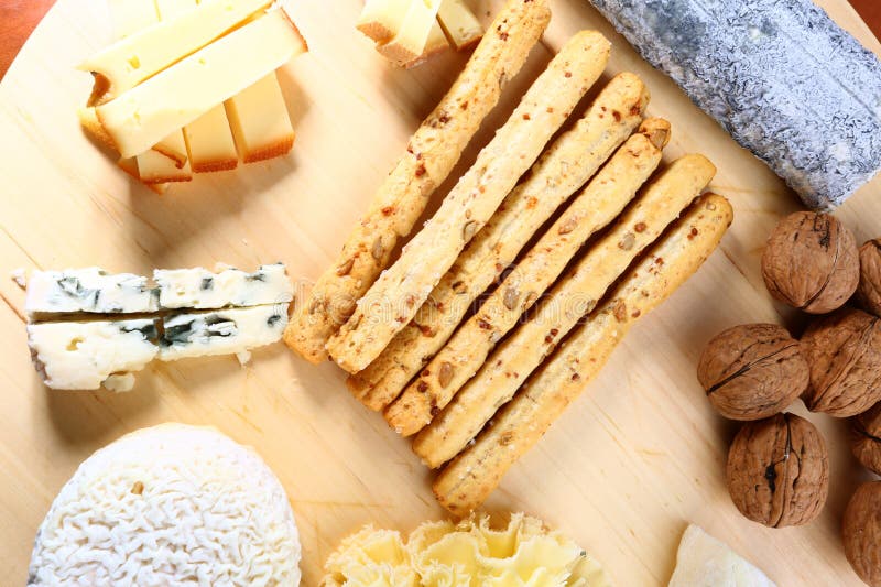 Queijo suíço e francês, variedade em tábua de madeira imagem de stock