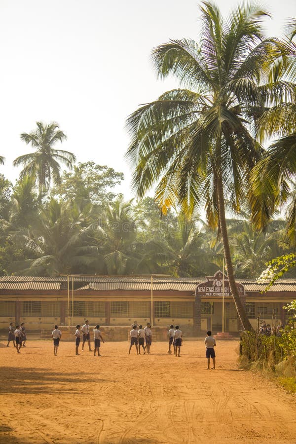 Indian schoolchildren playing football in the courtyard of the school on a yellow ground against royalty free stock photos Indian schoolchildren playing football in the courtyard of the school on a yellow ground against royalty free stock photos
