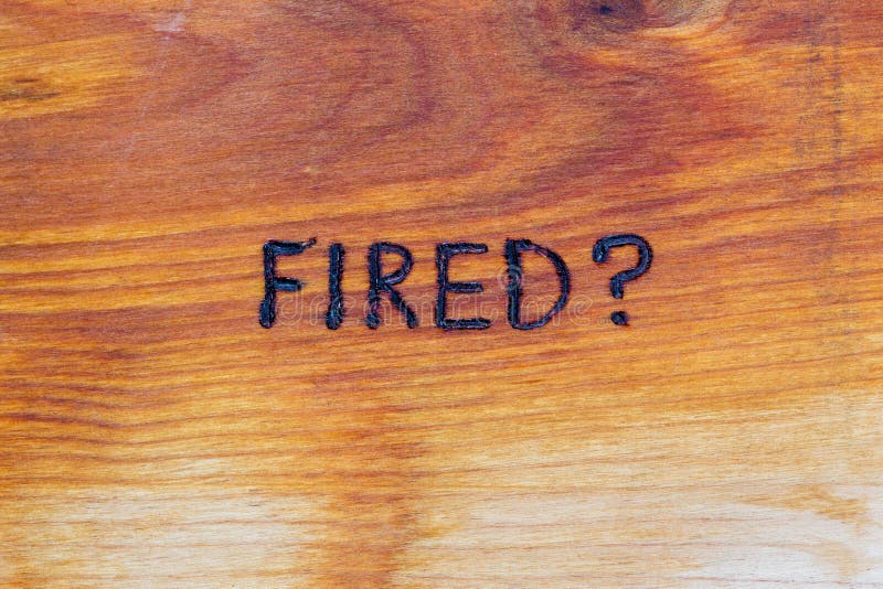 Question fired handwritten with hand woodburner on flat brown wood surface royalty free stock photo