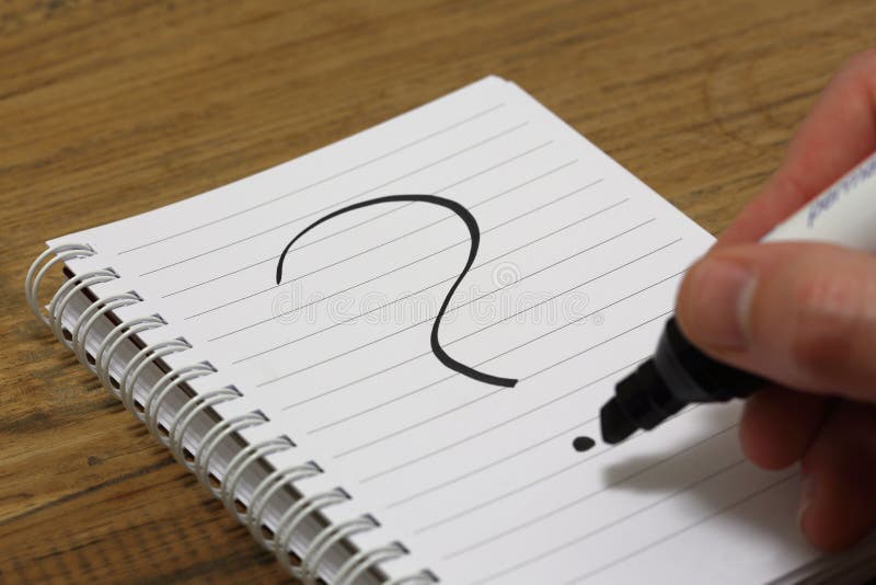 Question mark being written on paper