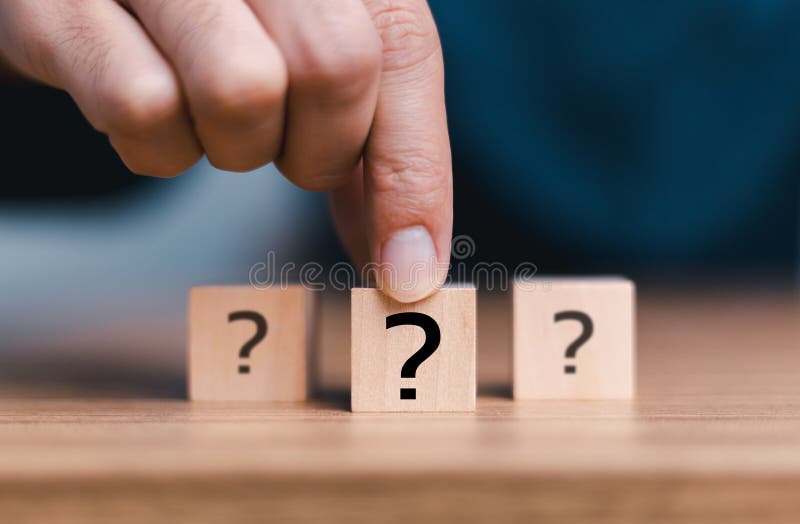 Question Mark and Problem-Solving Concept. Businessman selected a cube block with sign question mark symbol. Finding answers to royalty free stock photo