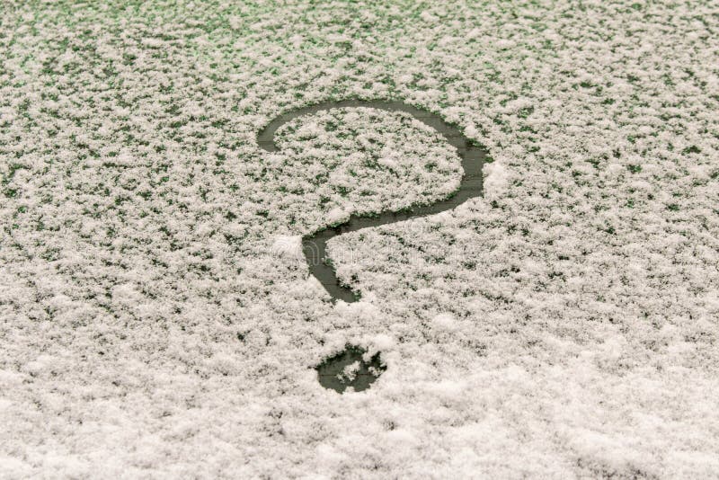 A question mark on the snow-covered car window. The concept of finding answers to questions royalty free stock photo