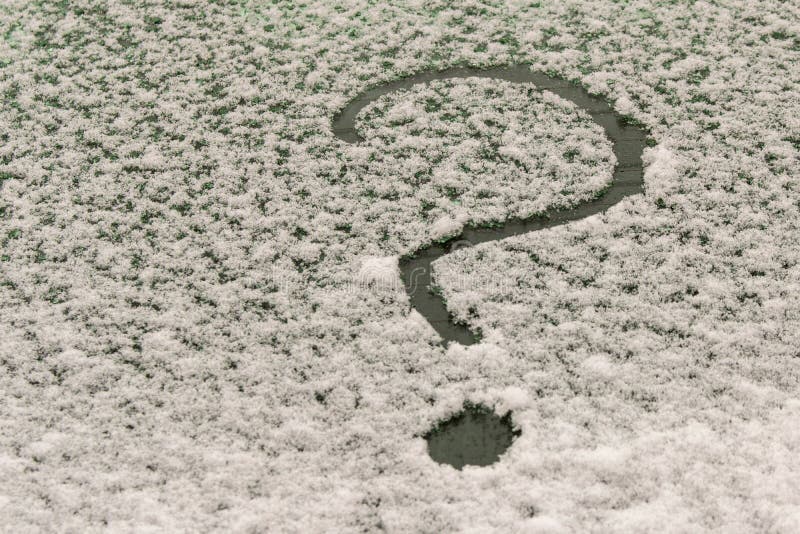 A question mark on the snow-covered car window. The concept of finding answers to questions stock photos