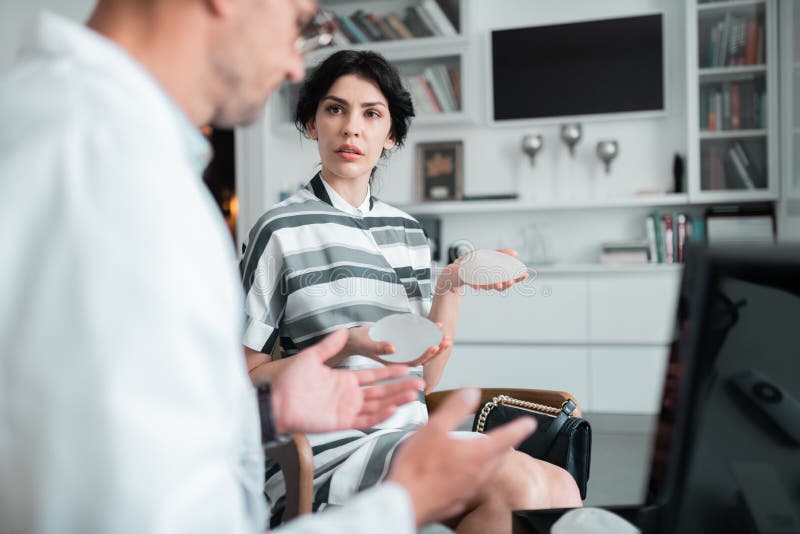 Client of Plastic Surgeon Asking Questions about Implants Stock Image