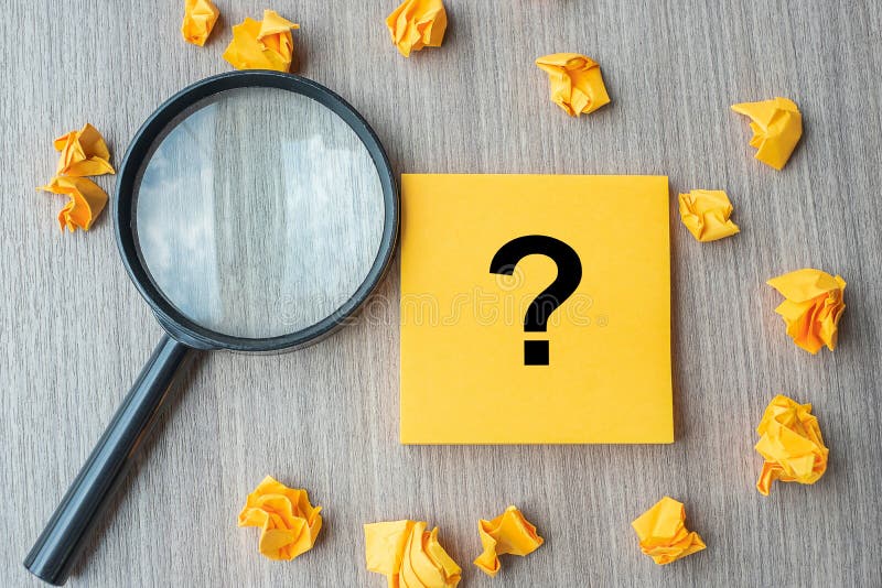 Questions Mark ? word on yellow note with crumbled paper and magnifying glass on table background. Idea, Analysis, Keyword, stock photos Questions Mark ? word on yellow note with crumbled paper and magnifying glass on table background. Idea, Analysis, Keyword, stock photos