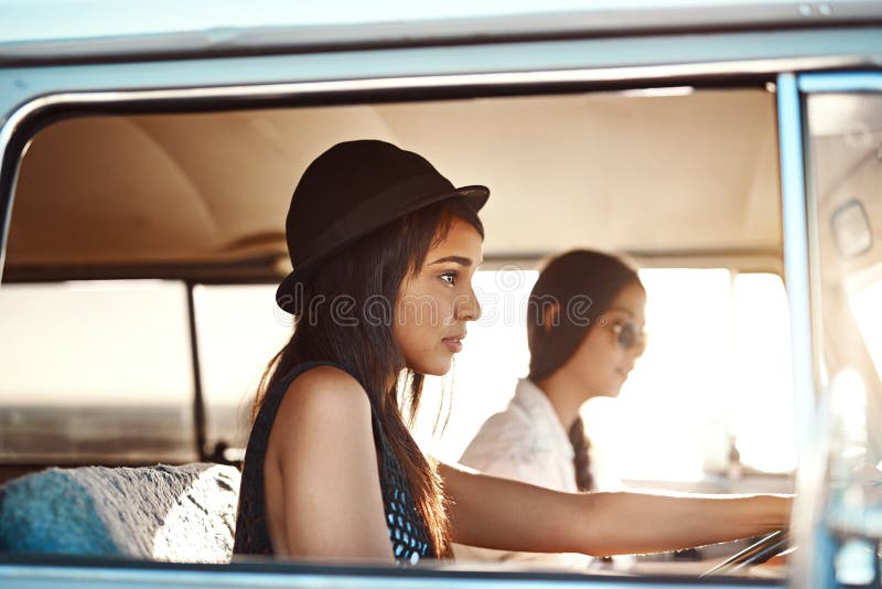 The Quiet at the End of a Road Trip. Two Young Women Going on a Road Trip. Stock Photo Image