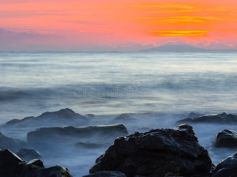 Quiet sea coast with stones at the twilight