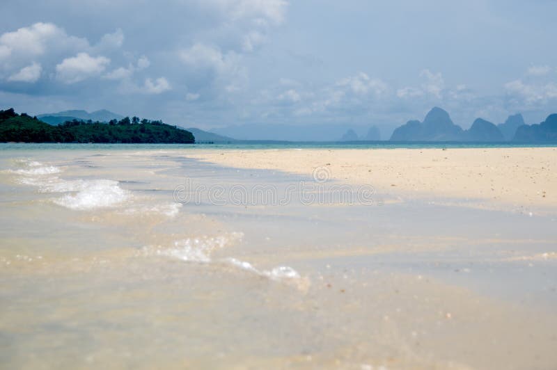 The quiet waves go in coral sands beach at Phang Nga Bay.