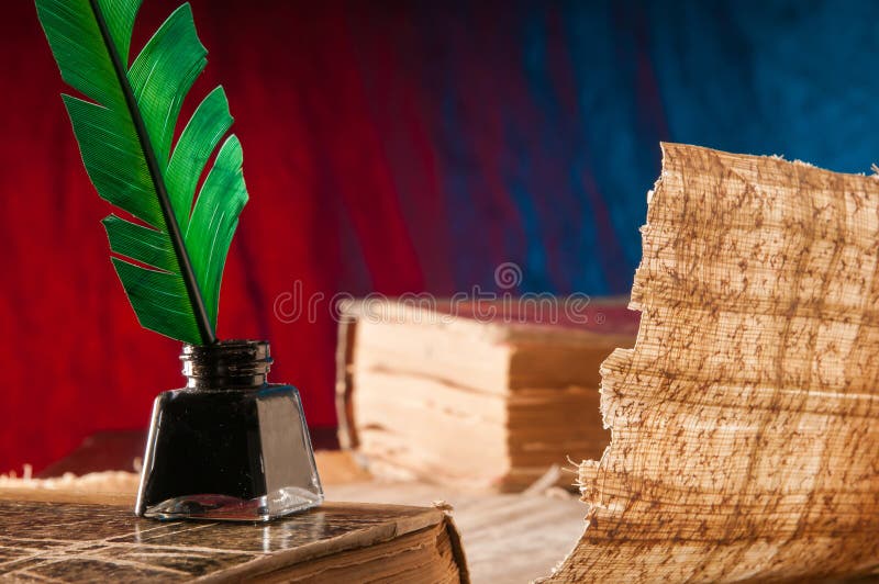 Quill pen and papyrus paper stock photography