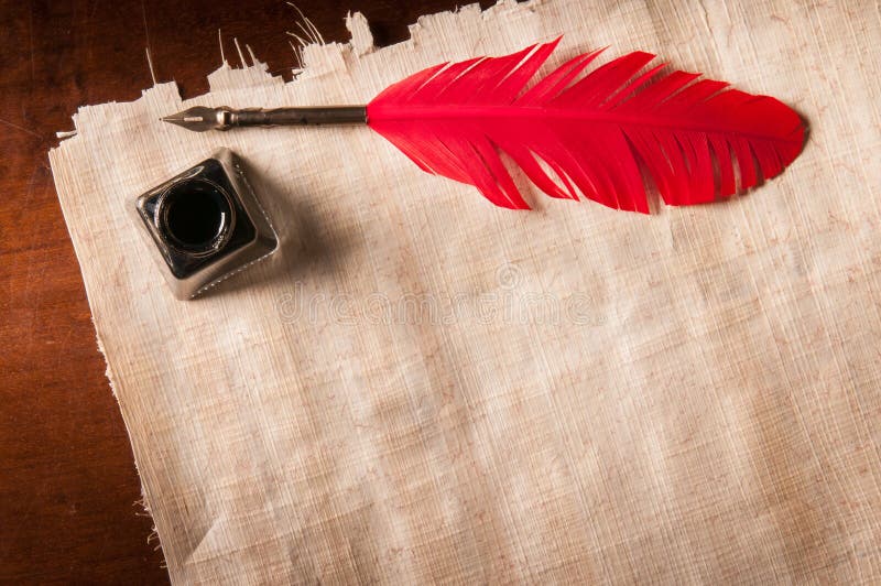 Quill pen and papyrus paper stock image