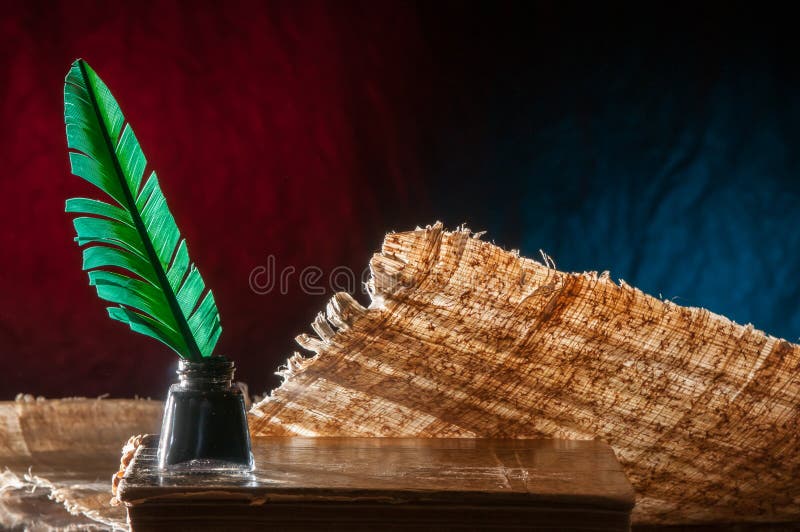 Quill pen and papyrus sheet stock image