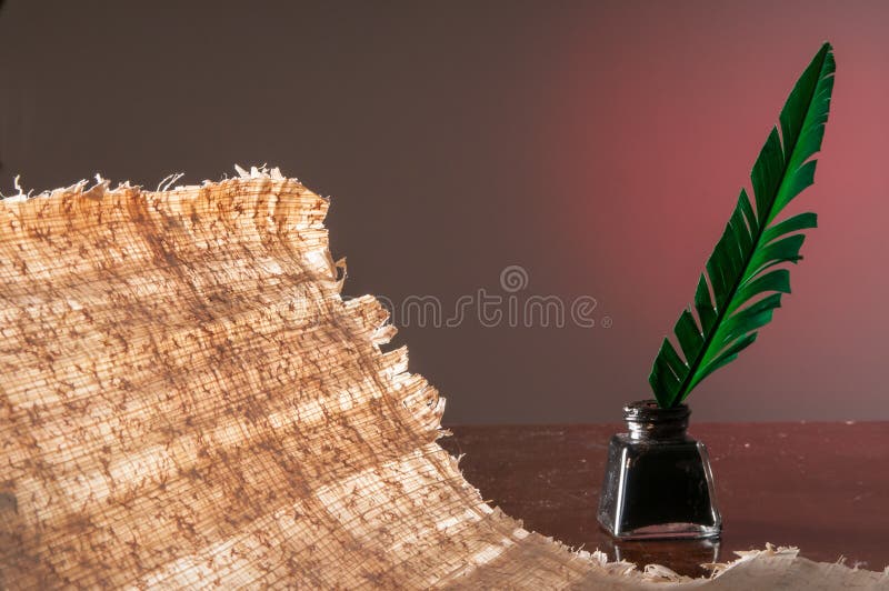 Quill pen and papyrus sheet stock photo