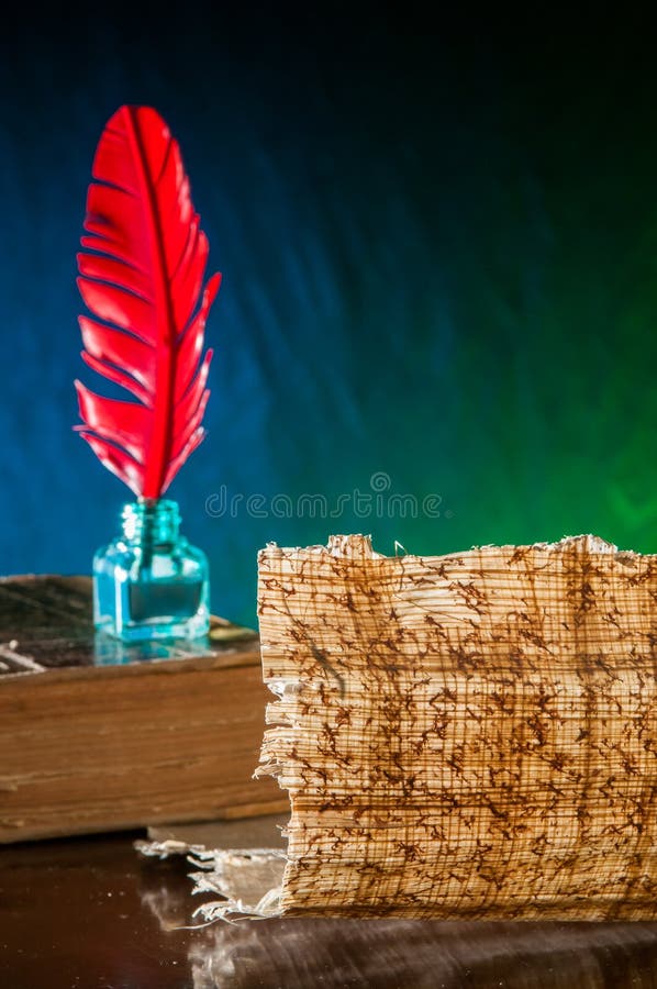 Quill pen and papyrus sheet royalty free stock photography