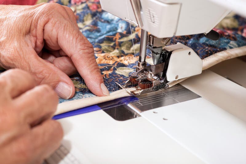 Quilter Sewing on Binding To Quilt. Stock Image Image of work