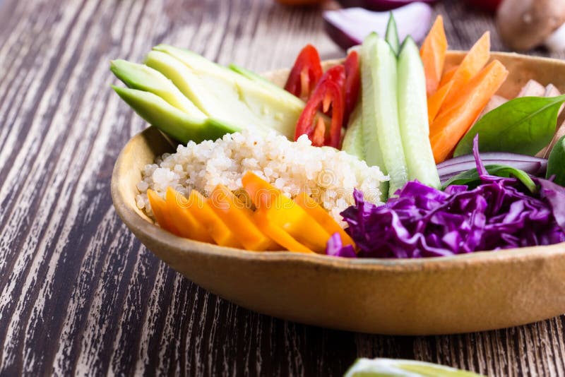 Quinoa veggie bowl with colorful fresh vegetables and fruits