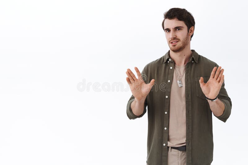 Quit this bullshit. Serious-looking busy handsome guy showing stop, enough or dont gesture with hands raised near chest