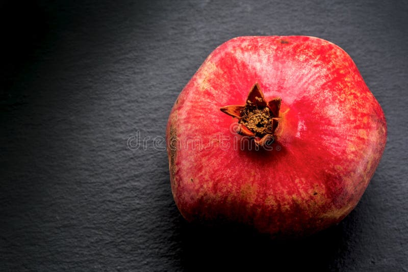 Ruby red pomegranate on shale stock image Ruby red pomegranate on shale stock image
