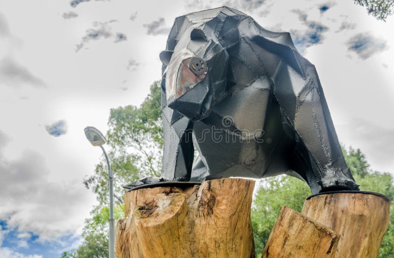 QUITO, ECUADOR - JANUARY 31, 2018: Close up of metallic bear over a wooden structure at outdoors in the La Alameda Park royalty free stock photography QUITO, ECUADOR - JANUARY 31, 2018: Close up of metallic bear over a wooden structure at outdoors in the La Alameda Park royalty free stock photography