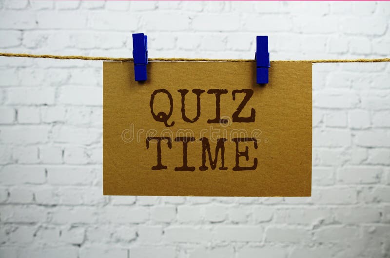 Quiz Time text on paper card hanging with rope on white brick background stock images