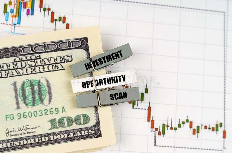 On the quote chart there are dollars and clothespins with the inscription - Investment Opportunity Scan stock images